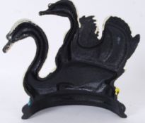 A decorative 20th century painted cast metal doorstep in the form of swans.