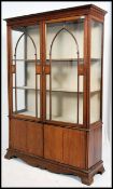 A large Edwardian mahogany inlaid display cabinet vitrine having astragal glazed doors enclosing a