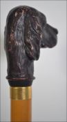 A 20th century walking cane having a Setter dog top,