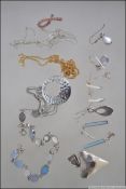 A collection of silver items to include a silver and mother of pearl bracelet, assorted earrings,