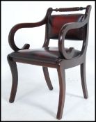 A good quality Regency revival mahogany and leather desk chair having rope twist top rail over