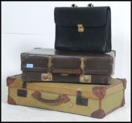 A vintage stack of suitcases to include a D - Mob case, a good leather case,