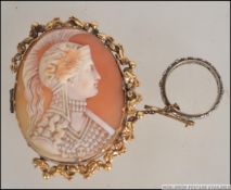 A 19th century Cameo brooch mounted on a gold metal rococo mount along with a gold metal eternity