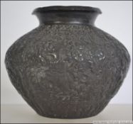 A late 19th century bronze Asiatic worked bowl / planter depicting deities and floral motifs.