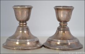 2 silver hallmarked stub candlesticks with ribbed decoration and single sconces to each.