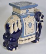 A large floor standing ceramic plant stand in the form of an Indian elephant H44cm