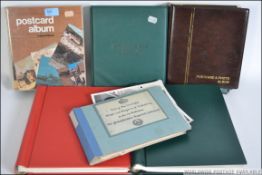 A collection of 20th century postcards in albums to include many scenes together with stamp albums