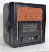 A 1930's Art Deco bakelite valve radio with decorative facia,