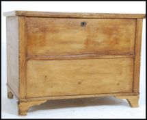 A large early 20th century French pine blanket box chest having hinged top over panel sides with