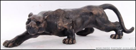 A large cast iron figure of a Panther hunting. The panther in a low stalking position. 39cm long.