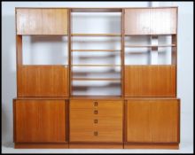 A 1970's retro G-Plan modular teak wood room divider bookcase having 3 sections to include sliding