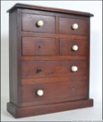 A Victorian mahogany apprentice piece chest of drawers being raised on plinth base with short over