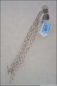 Two white metal necklaces both with heart shaped pendants along with a matching bracelet.