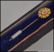 A 19th century Victorian 15ct stick / hat pin wirth lozenge top having inset 1pnt diamond to