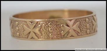 A 9ct gold band ring decorated with Maltese cross, illegible markings to shank Size P.5 / Weight 2.