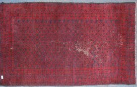 A 20th century Persian rug with unusual blue medallion design on red ground having geometric