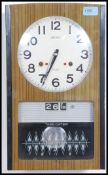 A stunning retro Seiko 30 day ' Time Dator ' wall clock in decorative retro case with pendulum and