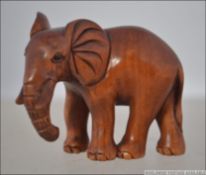 A Japanese carved figure - netsuke type of an elephant bearing a signature to the base