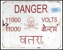 A vintage enamel 20th century sign Danger 11000 Volts. Sign in both English and Hindi.