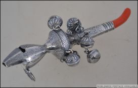A continental silver 800 marked babies rattle having a coral adorned mouthpiece. Weight 47.