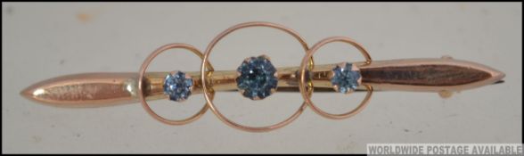 A 9ct gold and believed aquamarine coloured stone brooch having wire hoop surround.