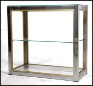 A retro 1970's three tier glass and chrome shop counter display stand having a chrome tubular frame