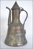 A 19th century hand beaten copper teapot of Turkish - Islamic form having scrolled handle with