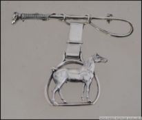 A hunting interest - horse riding silver ladies brooch in the form of horse and whip. Weight 11.