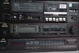 A retro JVC music stacking system, consisting of a tuner, amp,