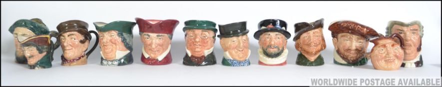 A good collection of twelve early miniature Royal Doulton Toby Jugs.