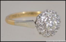 A ladies 18ct gold and platinum diamond cluster ring.