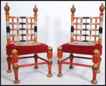 A pair of Indian hand painted red colourful throne chairs of decorative form having spindle