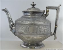 A Victorian silver plated ( EPBM ) teapot of rococo large form being chase decorated with vertical