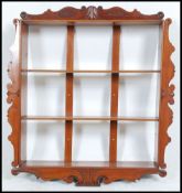 A good mid 19th century solid Victorian mahogany set of shelves with embellished central mounts top