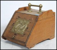 A Victorian oak and brass coal scuttle having brass star of david plaque to centre. Handle to top.