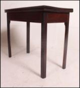 A Georgian 19th century solid mahogany tea table raised on squared legs with flip over table being
