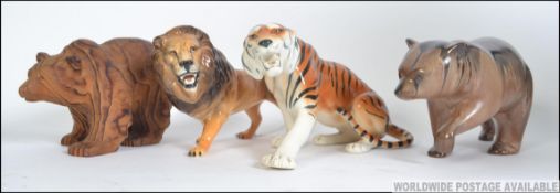 A collection of ceramics to include a Beswick prowling Lion, a USSR Tiger,