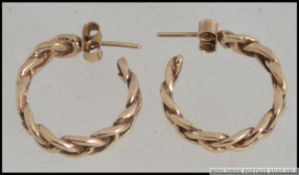A good pair of ladies 9ct gold / 375 marked ladies post hoop earrings of rop twist form,