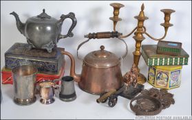A dealers lot to include tins, copper kettle, Victorian pewter kettle, candelabra, cannon, statue,