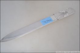 A large silver hallmarked paper knife with wheatsheaf handle having initials DP.