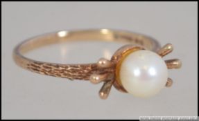 A 9ct gold hallmarked pearl ring with flash bow setting being marked for London possibly 1962.