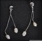 A pair of 18ct white gold and baroque pearl drop earrings.