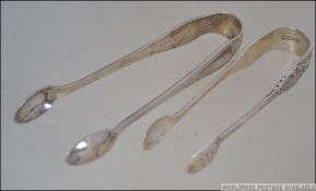 2 silver hallmarked pairs of sugar tongs,