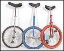3 20th century retro unicycles of varying colours by Pashley to include Red,