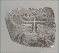 A silver Mexican 8 real coin ' piece of eight ' purported to be from the wreck of the Johanna.