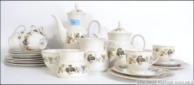 A Royal Doulton Larchmont pattern part tea service in a chintz flower design to include teapot,