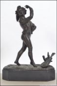 A 19th century French bronze figurine of a flouncing musician set to a marble plinth with lyre to