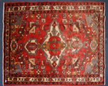 A good Persian handwoven rug with beautiful medallion on red ground with cube designs,