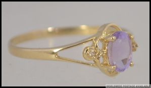 A 9ct gold and amethyst ladies ring being marked 9ct / 375 having diamond chip shoulders.