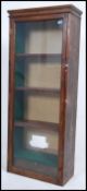 A Victorian style mahogany shop cabinet having glass door front with inset glass shelves under